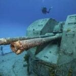 diver-near-the-gun-turret-on-a-shipwreck