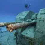 diver-near-the-gun-turret-on-a-shipwreck
