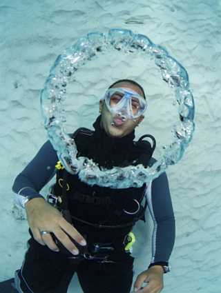 scuba-diver-blowing-bubble-rings-underwater