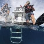 scuba-divers-enter-water-taking-a-giant-stride