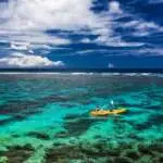 female-and-little-boy-paddling-canoe-on-a-lagoon